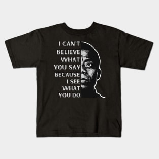 James Baldwin quote: "I can't believe what you say, because I see what you do." Kids T-Shirt